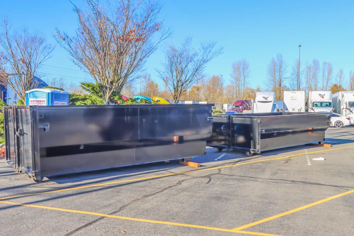 Professional dumpster rental service with roll-off container on residential driveway in Innsbrook